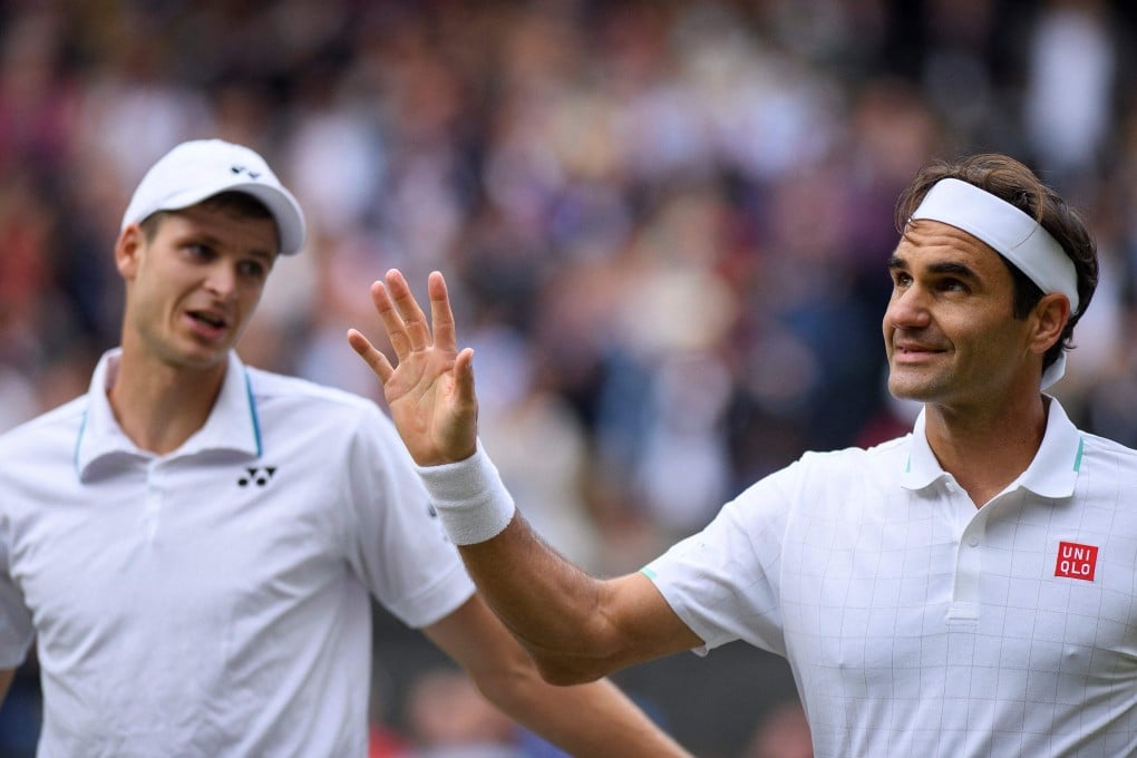 Switzerland’s Roger Federer with Poland’s Hubert Hurkacz after their quarter-final at Wimbledon. Photo: AFP
