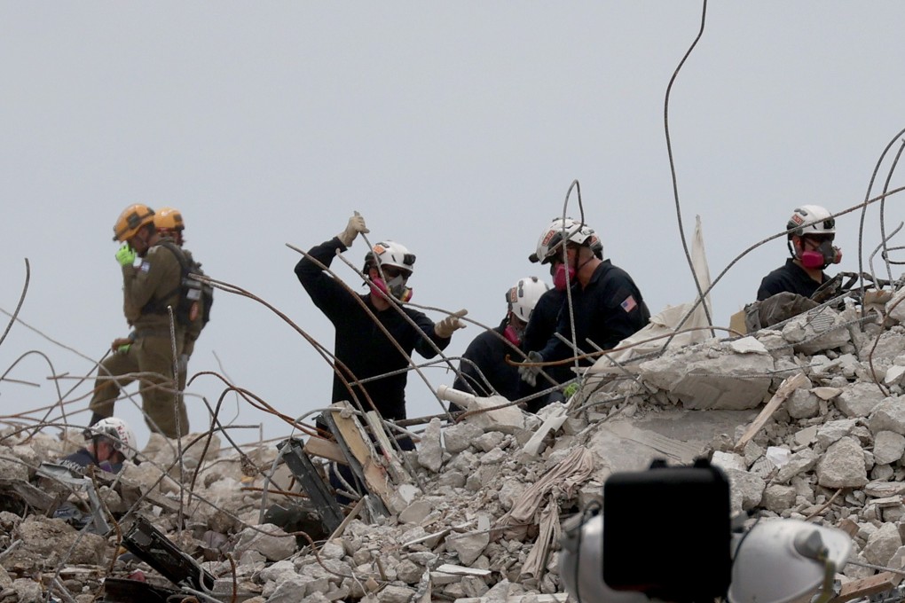 Search and Rescue teams look through the rubble of the collapsed 12-storey Champlain Towers South building in Surfside, Florida on Wednesday. Photo: Getty Images / AFP