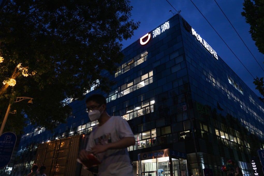 A pedestrian passes the Didi Chuxing headquarters at night in Beijing, China. Photo: Bloomberg