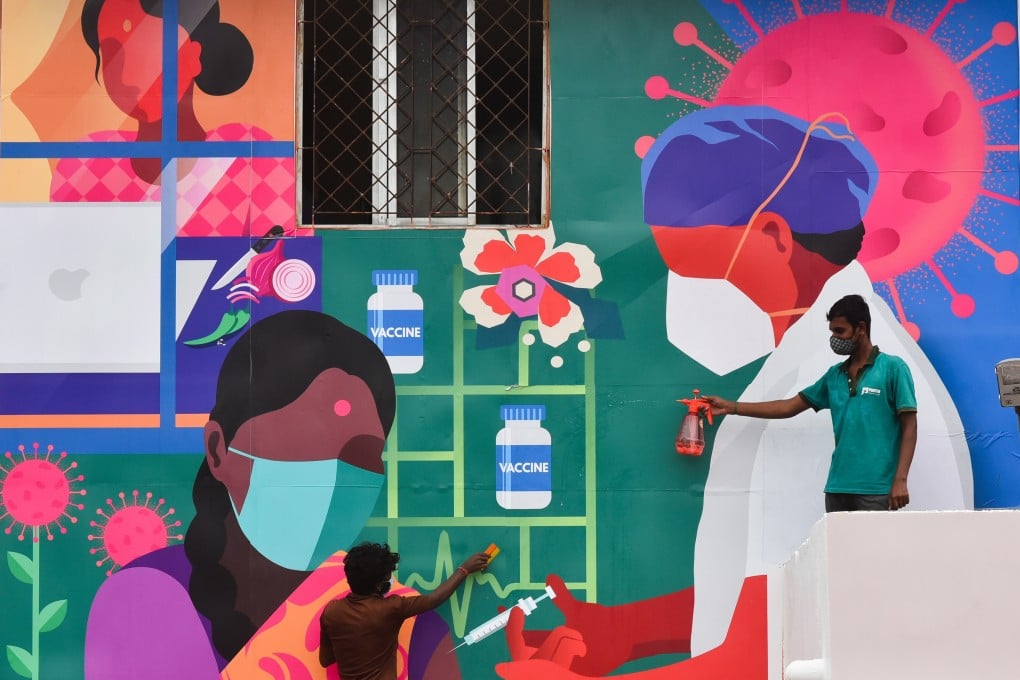 Indian workers give final touches to a Covid-19 mural in Chennai. Photo: EPA