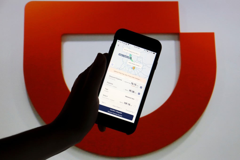 The app of Chinese ride-hailing giant Didi is seen on a mobile phone in front of the company’s logo in this illustration picture taken July 1, 2021. Photo: Reuters