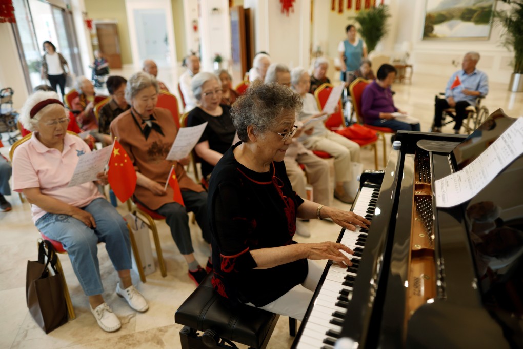 Wang Yiguang, 85, plays the piano during a group singing practice at Heyuejia, a care home for the elderly, in Beijing. Photo: Reuters