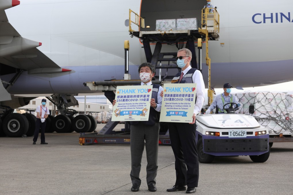 Taiwan's Health Minister Chen Shih-chung (left) and Brent Christensen, a US diplomat in Taiwan, in front of an plane delivering Moderna vaccines from the United States to Taiwan, at Taoyuan International Airport. Photo: Reuters
