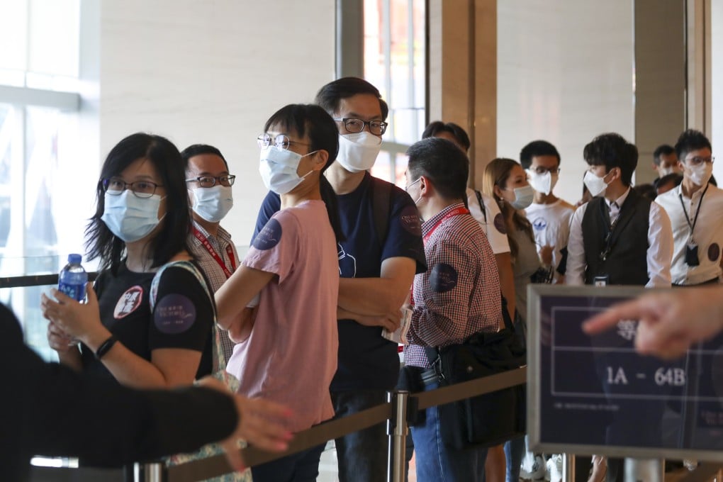 Property buyers queueing up for the One Victoria apartments in Kai Tak at the sales office of China Overseas Land and Investments (COLI) at the Exchange Tower on July 10, 2021. Photo: Xiaomei Chen.