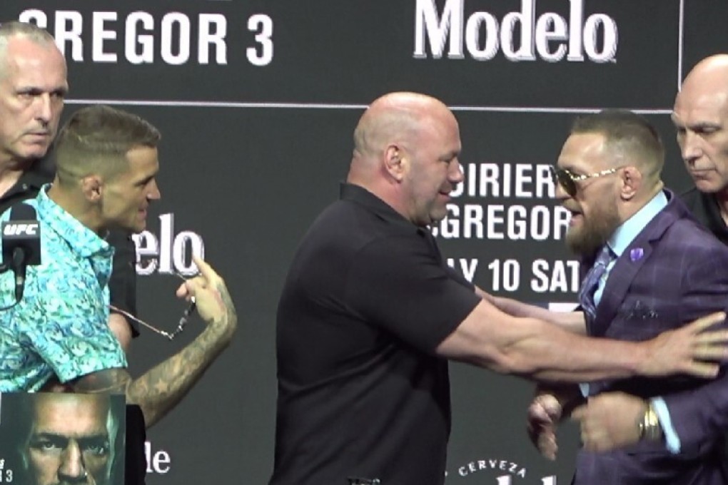 Dustin Poirier scuffles with Conor McGregor (left) ahead of their UFC 264 trilogy fight. Photo: Drake Riggs