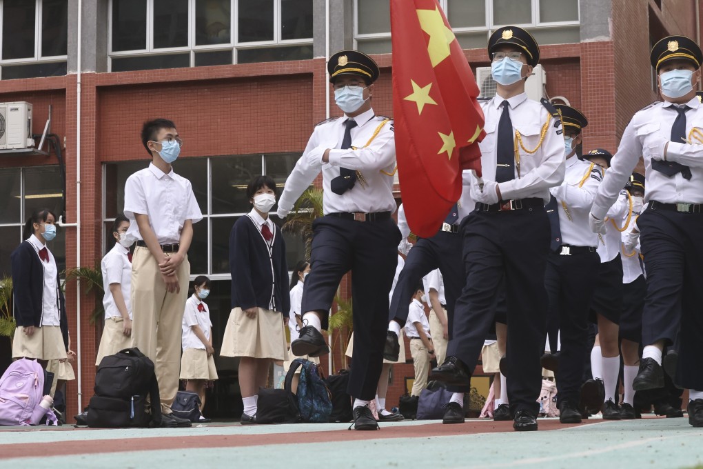 Pupils and teachers take part in a flag-raising ceremony at Gertrude Simon Lutheran College in Yuen Long on National Security Education Day. Photo: K. Y. Cheng