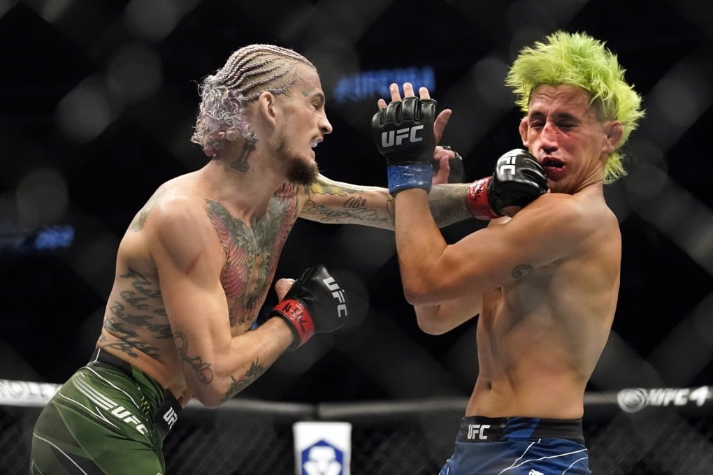 Sean O'Malley punches Kris Moutinho in their UFC 264 bantamweight fight. Photo: AP