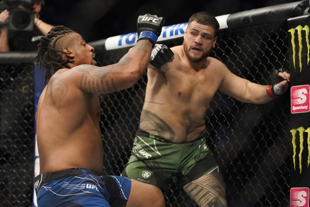 Tai Tuivasa punches Greg Hardy during their UFC 264 heavyweight bout. Photos: AP