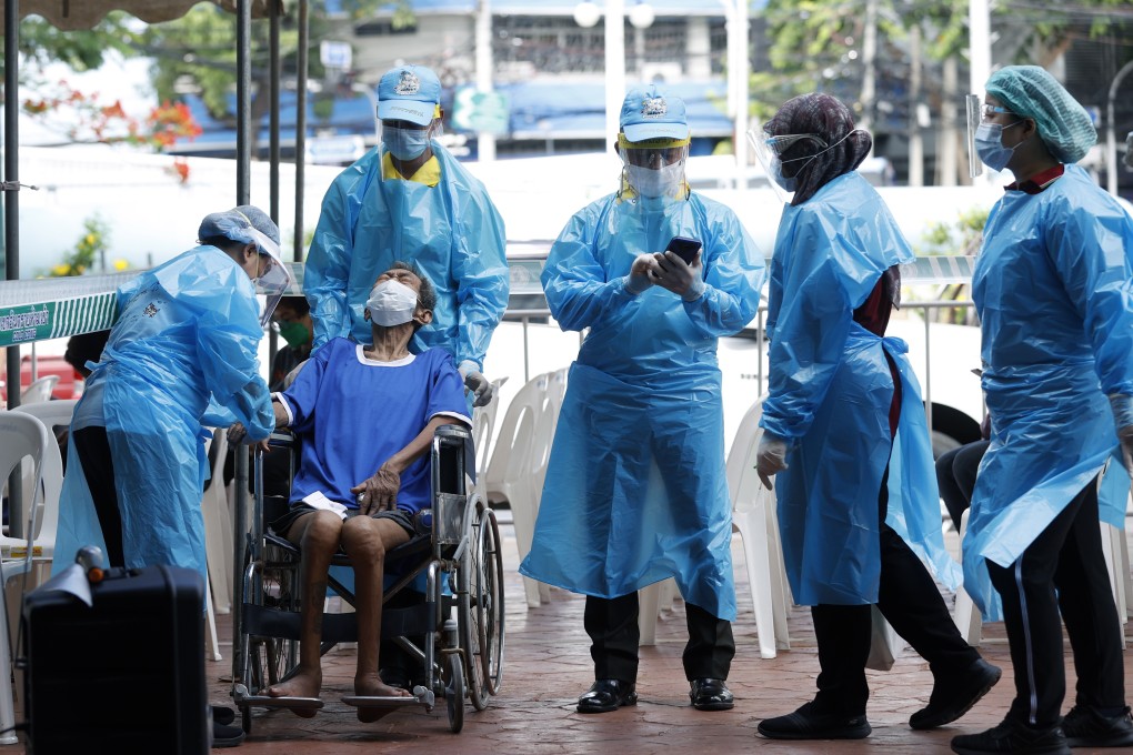A Thai man is tested for Covid-19 by health workers in Bangkok, as the government imposed stricter health restrictions. Photo: EPA-EFE