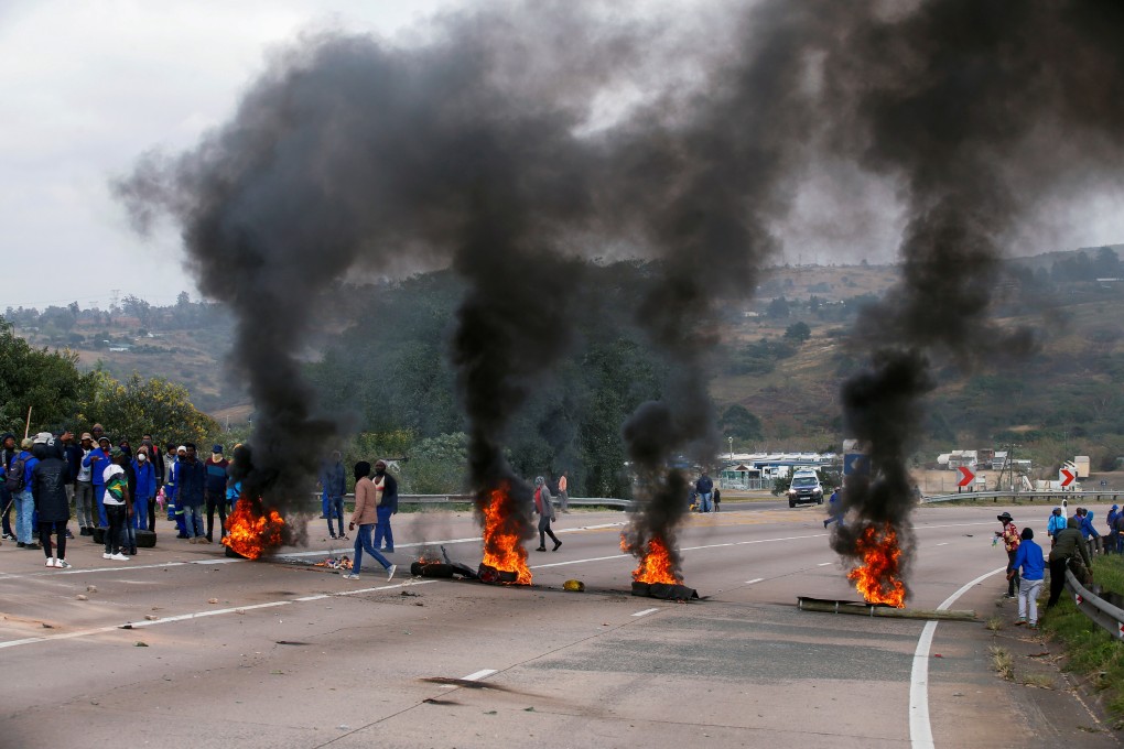 Supporters of Jacob Zuma block a road with burning tyres during a protest in Peacevale, South Africa on Friday. Photo: Reuters