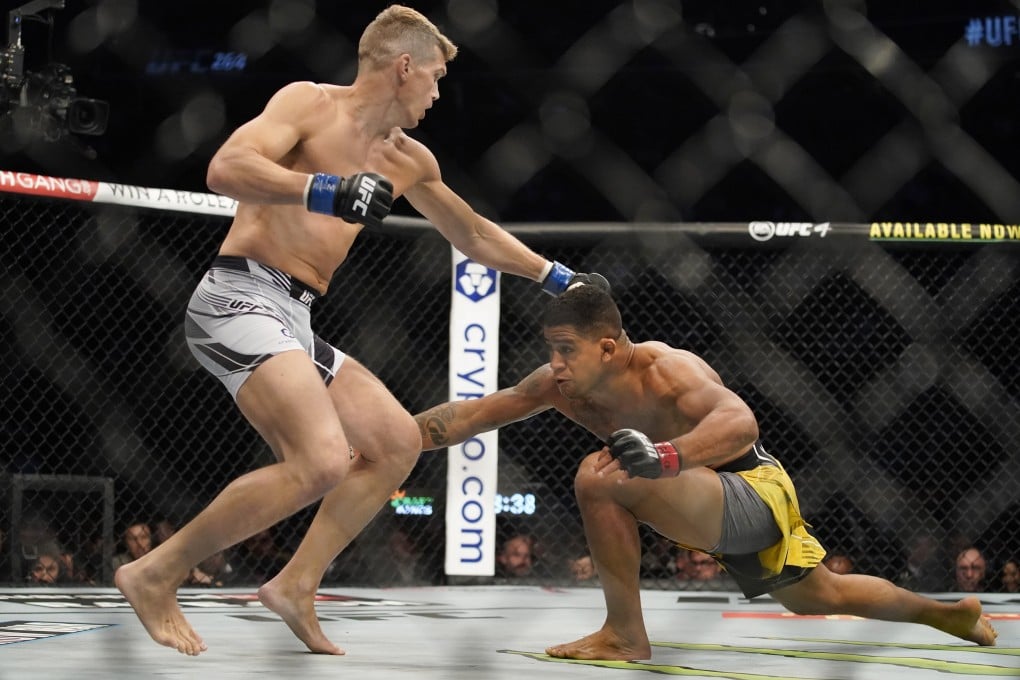 Gilbert Burns shoots for a takedown against Stephen Thompson in their UFC 264 welterweight bout. Photo: AP
