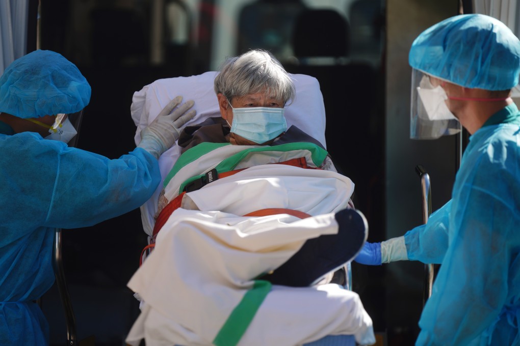 Medical workers with an elderly resident from a care home in Hong Kong. Only 5 per cent of such residents have received their jabs. Photo: Sam Tsang