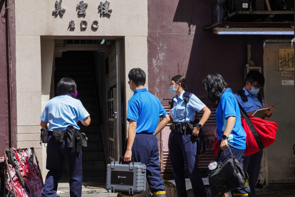 Police officers enter the building where the attack and fire took place in Tai Po. Photo: Winson Wong
