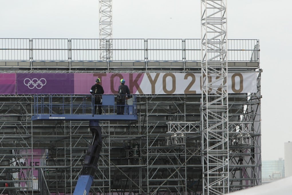 Workers at an Olympic venue under construction in Tokyo last month. The four men who were arrested work for a company that provides electrical services to the Games. Photo: Xinhua