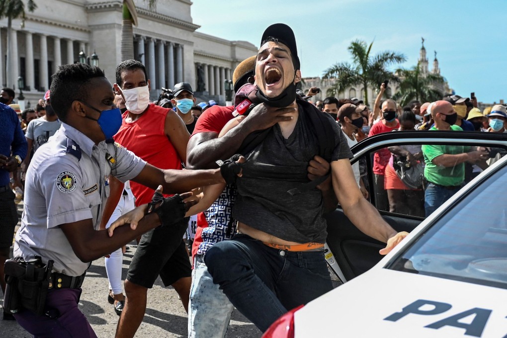 A protester is arrested during a demonstration against the government of Cuban President Miguel Diaz-Canel in Havana, Cuba on Sunday. Photo: AFP
