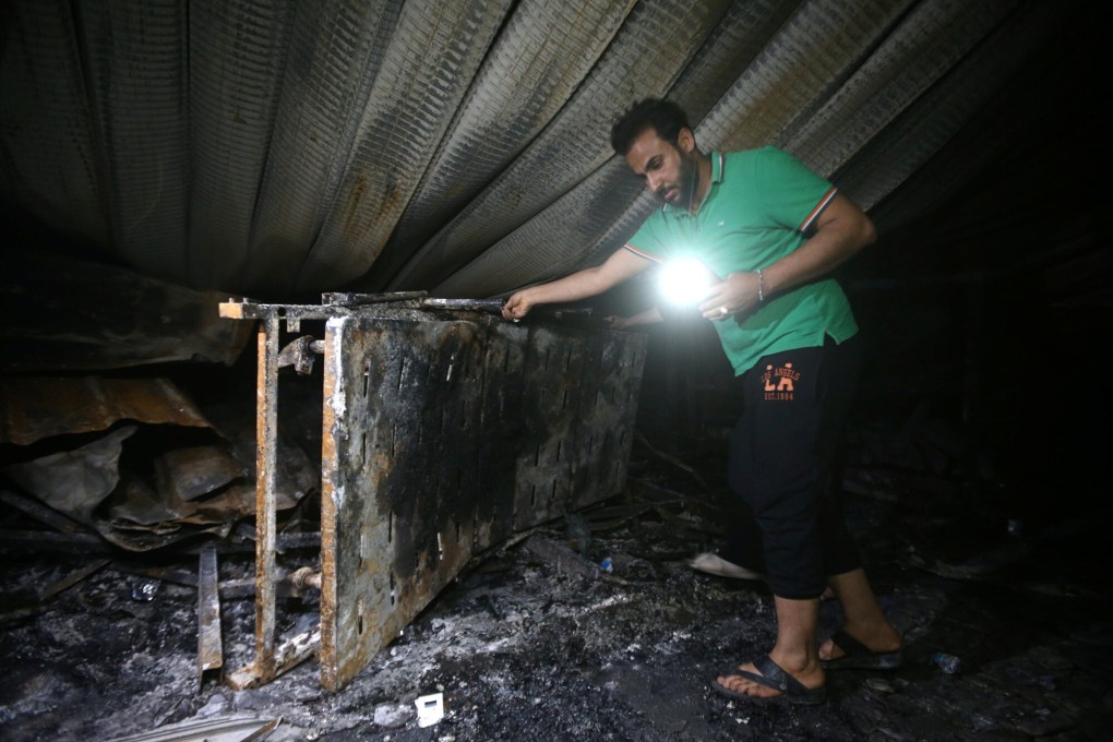 Rescuers combed the smoke-charred building in search of more bodies. Photo; Reuters