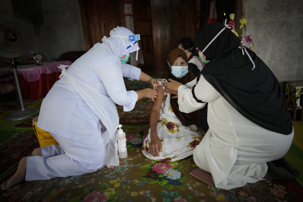 A nurse vaccinates a woman at her house in a rural part of Malaysia’s Selangor state on Tuesday. Photo: AP