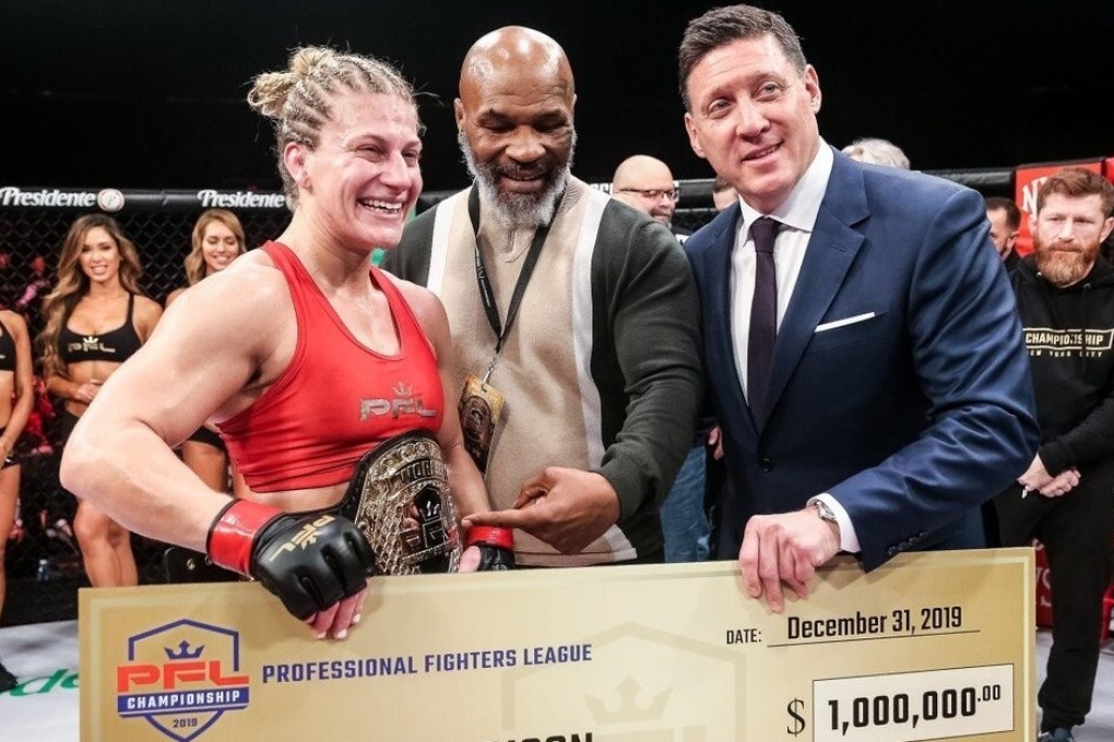 Peter Murray (right) and boxing legend Mike Tyson present 2019 women's lightweight champion Kayla Harrison with her US$1 million winner's cheque. Photo: PFL