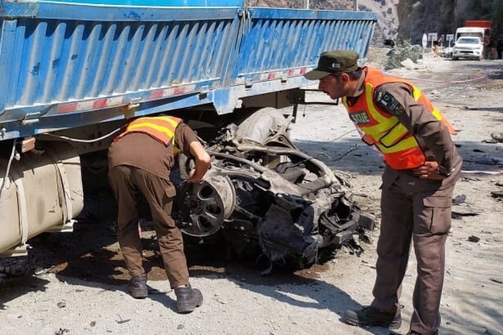 Rescuers inspect the scene of a blast on Wednesday that hit a bus carrying Chinese nationals to the site of Dasu dam in Pakistan. Photo: Rescue 1122 handout via EPA