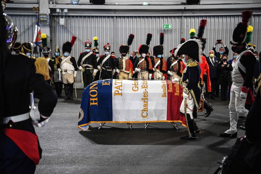 Men dressed as Napoleon-era fighters walk towards a French flag-covered coffin containing the remains of late French General Charles Etienne Gudin during a ceremony at Le Bourget airport near Paris on Tuesday. Photo: AFP