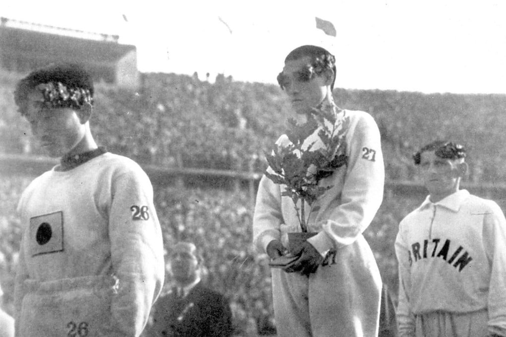 Sohn Kee-chung stands atop the podium with his head lowered after winning gold in the marathon at the 1936 Berlin Olympic Games. Photo: Kyodo via Reuters