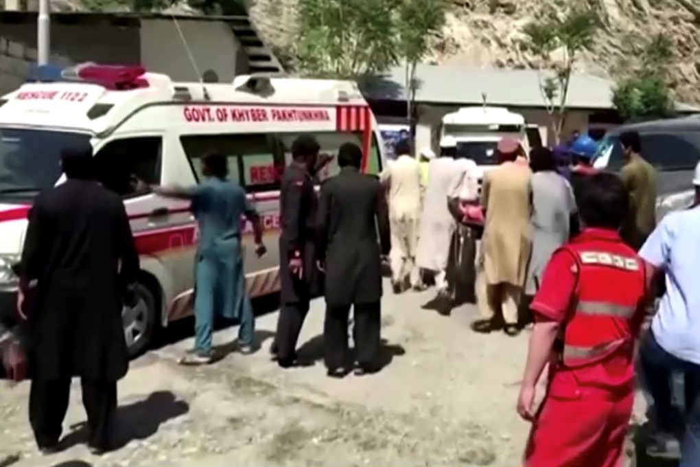 People wheel a gurney towards an ambulance outside a hospital in Dasu, after a bus with Chinese nationals on board plunged into a ravine in Kohistan, Pakistan, following a blast. Photo: Reuters