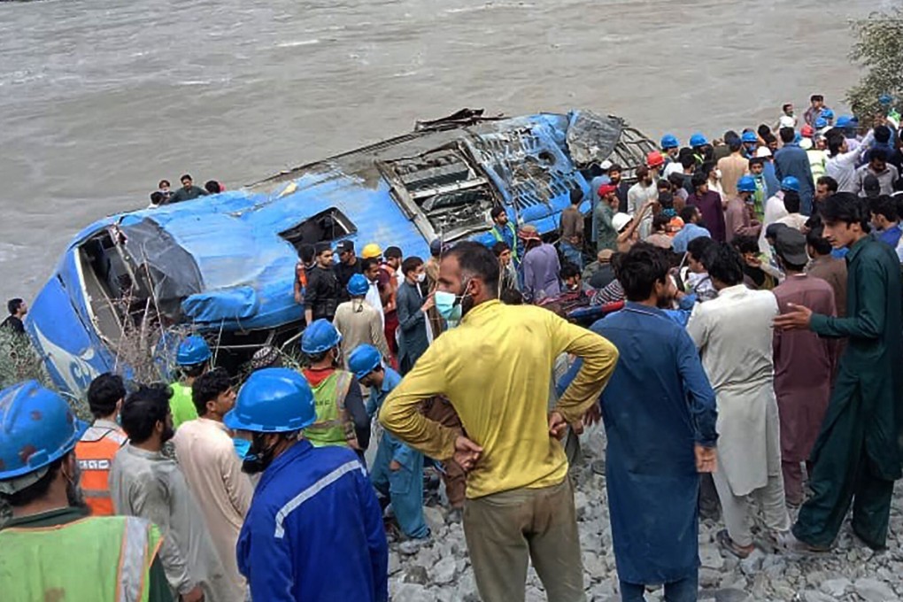 Rescue workers and onlookers in Pakistan gather around the wreckage of a bus which plunged into a ravine following an explosion, killing 13 and injuring 36. Most of the victims were Chinese nationals. Photo: AFP