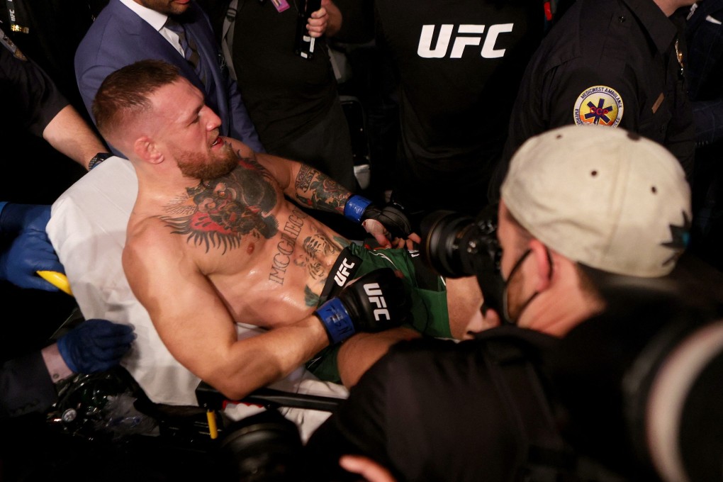 McGregor is carried out of the T-Mobile Arena on a stretcher after breaking his leg in the first round of his lightweight bout against Dustin Poirier. Photo: AFP