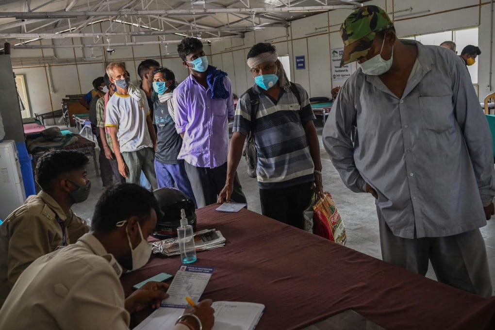 Homeless people in New Delhi queue up at a shelter where officials help them to register for the country’s vaccination programme. Photo: AFP