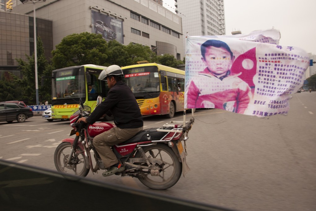 Guo Gangtang’s son was kidnapped 24 years ago, and he spent many years riding around on a motorcycle asking for help to find his son. They were reunited on Tuesday. Photo: Getty Images