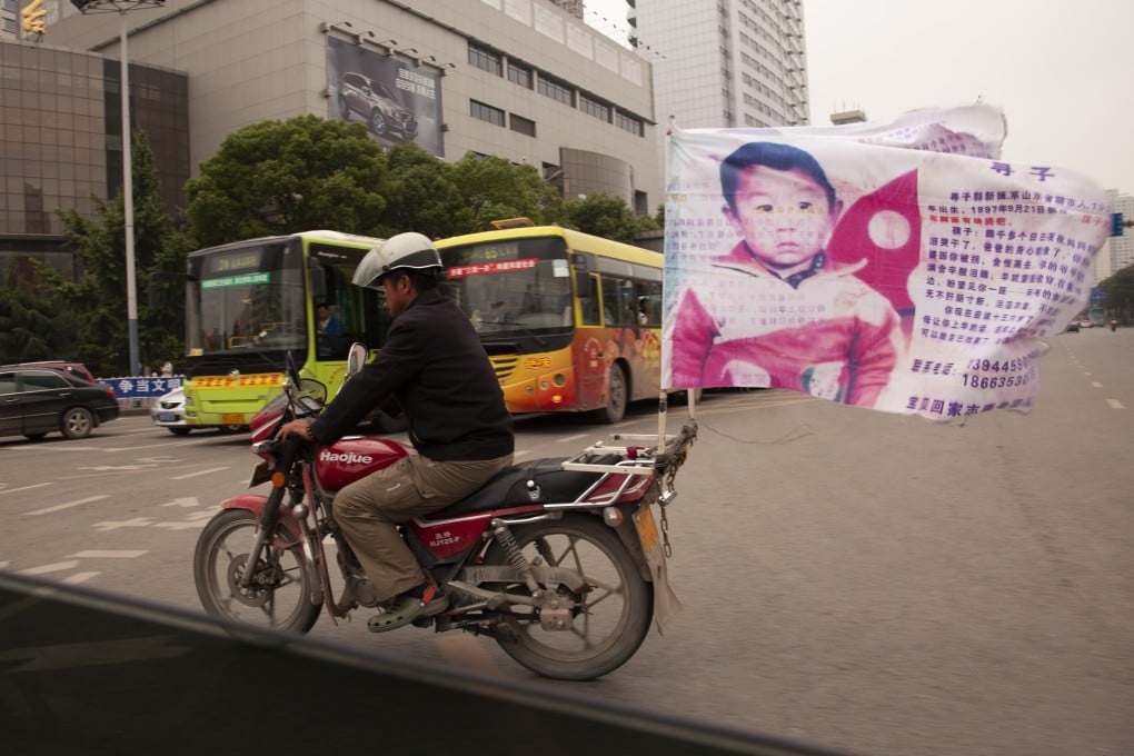 Guo Gangtang’s son was kidnapped 24 years ago, and he spent many years riding around on a motorcycle asking for help to find his son. They were reunited on Tuesday. Photo: Getty Images