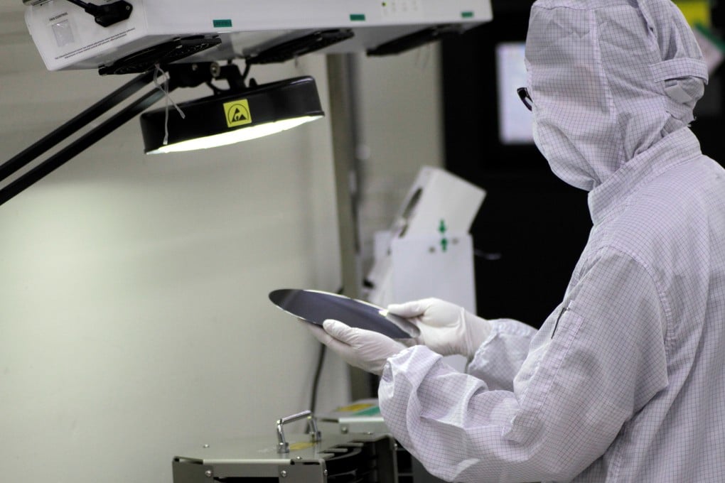 A worker checks a silicon wafer at the Singapore factory of UTAC, which was bought by Wise Road Capital. Photo: Reuters