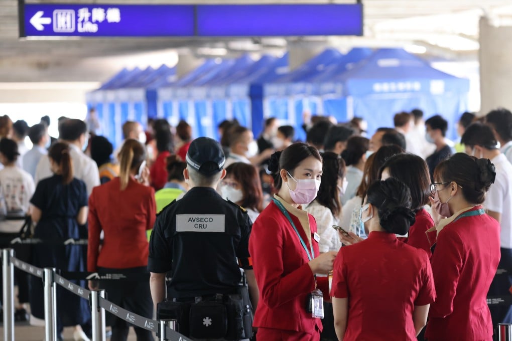 Staff subject to compulsory Covid-19 testing queue at a mobile sample collection station at Hong Kong International Airport. Photo: Nora Tam