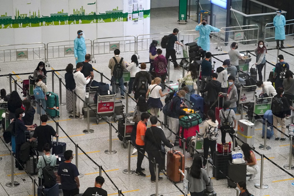 Passengers queue at Hong Kong International Airport before being transported to designated quarantine hotels. Photo: Felix Wong