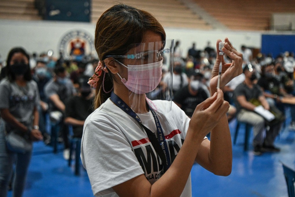 A health worker prepares a dose of the Pfizer Covid-19 jab at a vaccination centre in Manila, Philippines. Photo: AFP