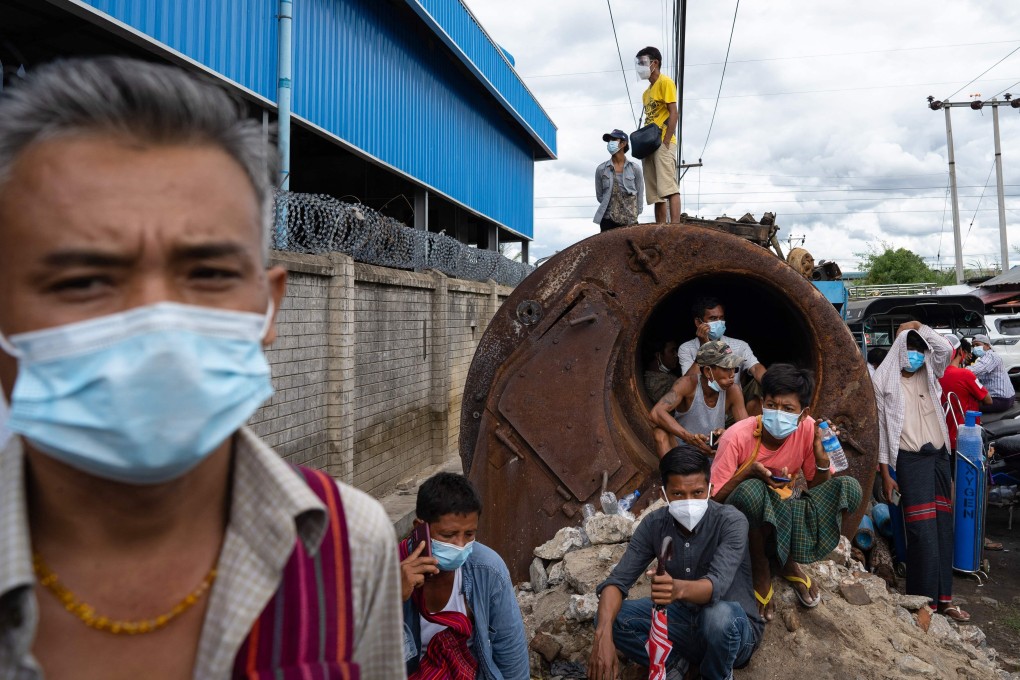 People wait to fill up empty oxygen canisters in Mandalay on July 13, 2021, amid the coronavirus pandemic. Photo: AFP