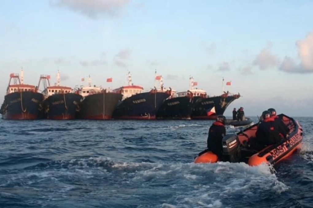 A Philippine coastguard patrol boat passes Chinese vessels at Whitsun Reef in the Spratlys in April. Manila is among those who have been more vocal in criticising Beijing over the South China Sea. Photo: EPA-EFE