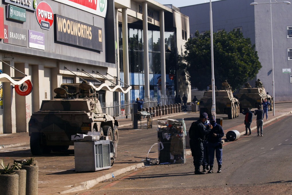Military tanks patrol near a shopping centre damaged after several days of looting following the imprisonment of former South Africa President Jacob Zuma in Durban, South Africa. Photo: Reuters