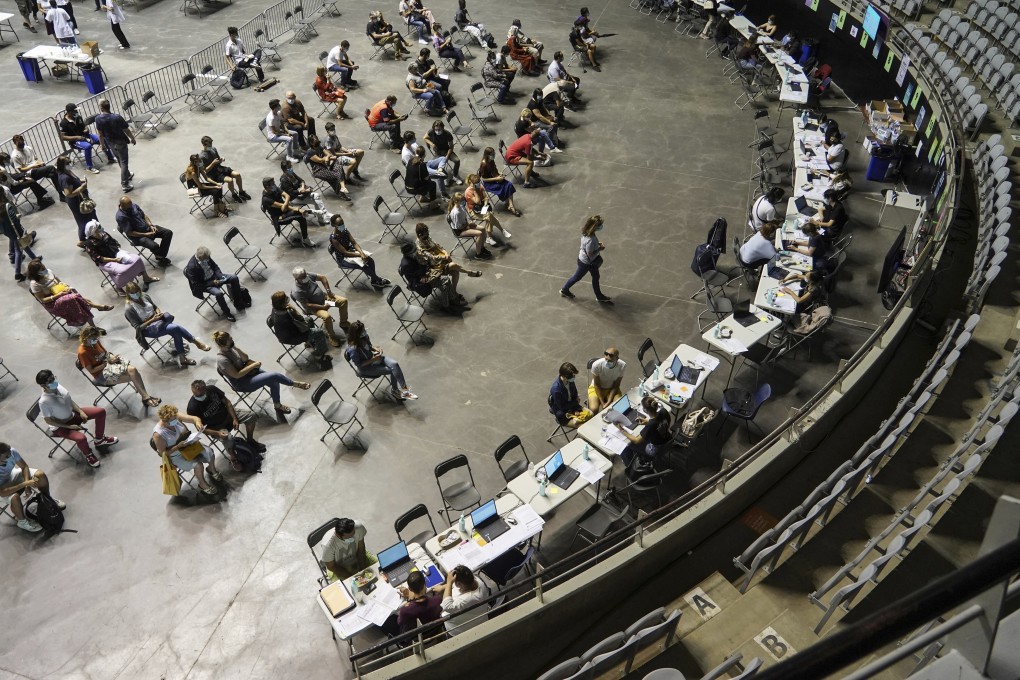 People wait to receive the Pfizer Covid-19 vaccine in Lyon, France. Photo: AP
