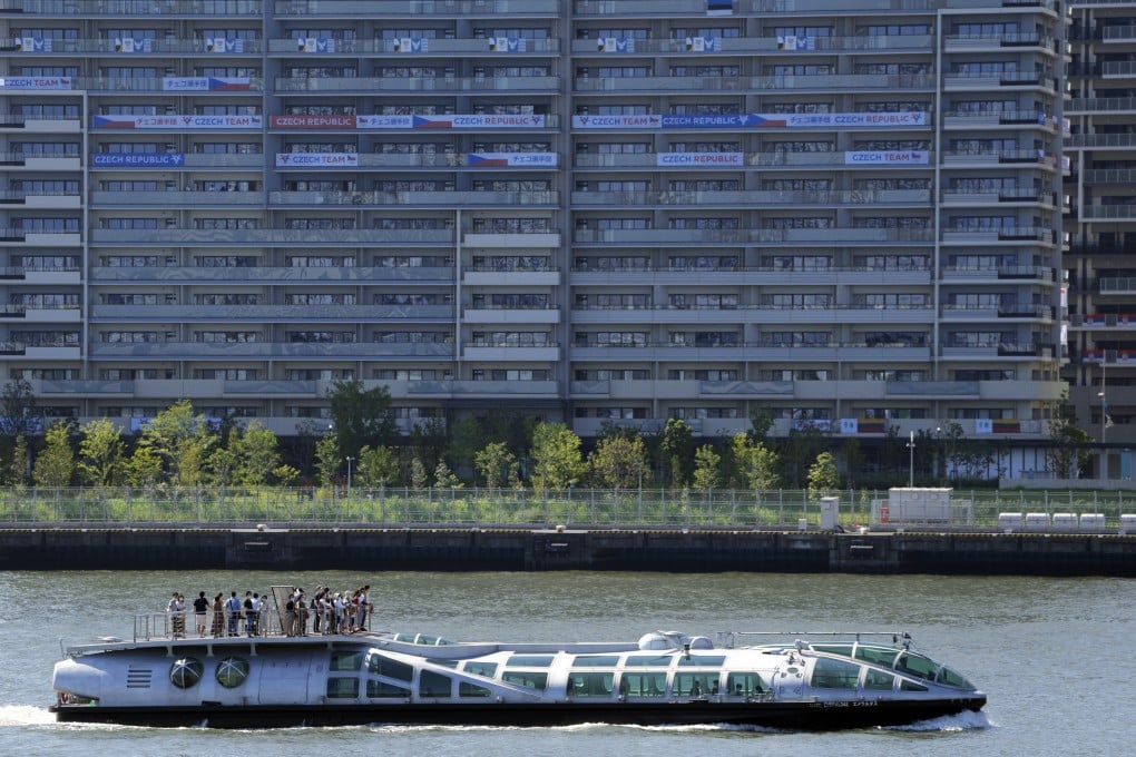 A tourist ship cruises past the Olympic Village in Tokyo on Saturday. Photo: EPA-EFE