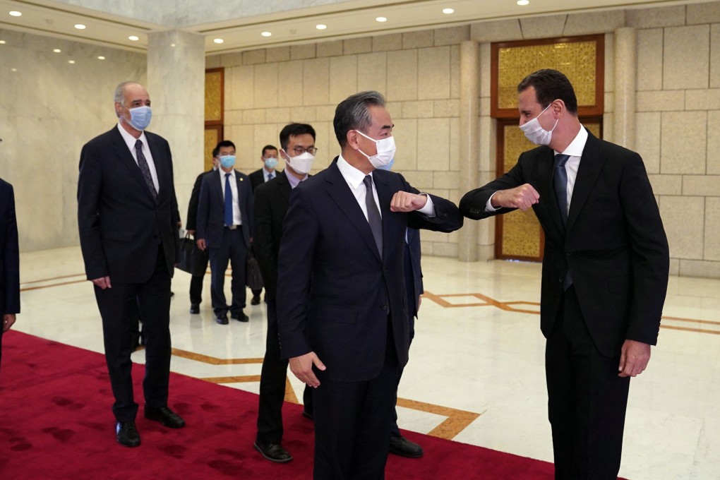 Syria’s President Bashar al-Assad, right, greets China’s Foreign Minister Wang Yi in Damascus, Syria on Saturday. Photo: AFP