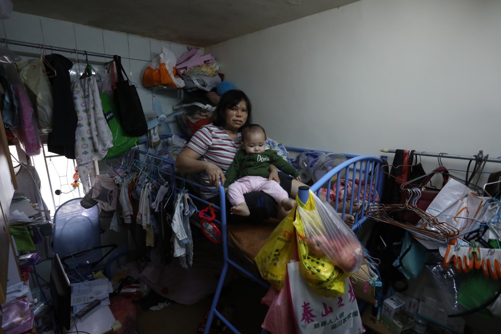 Ho Mei-ying and her son Zhang Hoi-shun, who live with two other family members in a 100 sq ft subdivided flat in Cheung Sha Wan. Photo: Jonathan Wong
