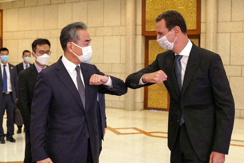 Syrian President Bashar al-Assad (right) greets Chinese Foreign Minister Wang Yi in Damascus. Photo: AFP