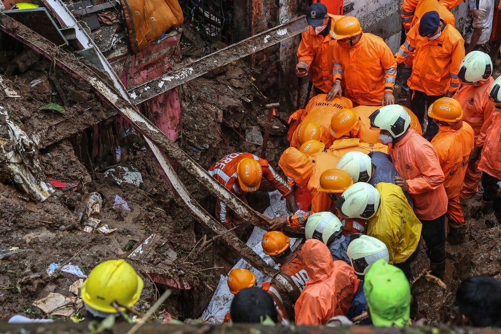 National Disaster Response Force staff recover a body from the rubble after a landslide at a Bharat Nagar slum in Chembur, Mumbai, India on Sunday. Photo: EPA-EFE,