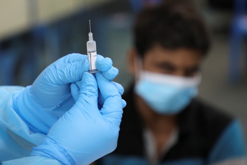 A medical worker prepares a coronavirus vaccine shot. More than 14 million doses have been administered in Malaysia since February, with 14 per cent of the population now fully vaccinated. Photo: Reuters