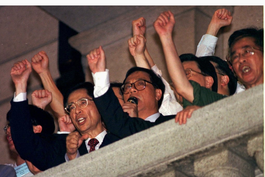 Martin Lee (left) and other Hong Kong pan-democrats address a crowd from the balcony of the former Legco building on the night before the handover. Photo: Reuters