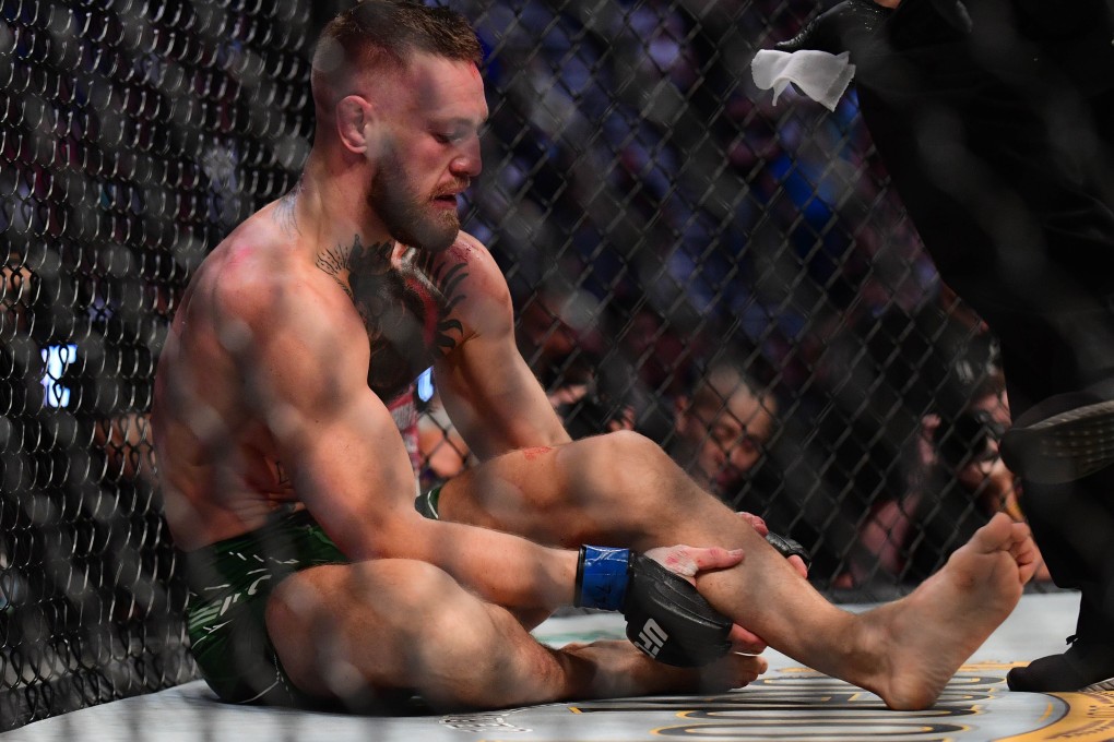 Conor McGregor holds his leg after suffering an injury against Dustin Poirier at UFC 264. Photo: USA TODAY Sports