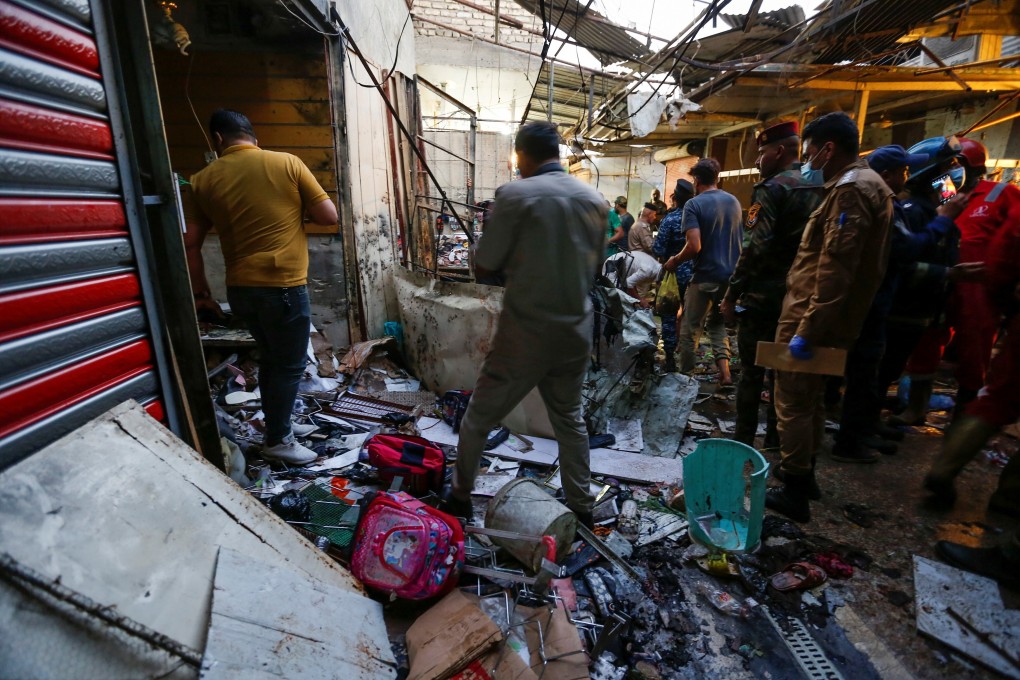 Iraqi security forces inspect the site of an explosion in the Sadr City district of Baghdad on Monday. Photo: Reuters