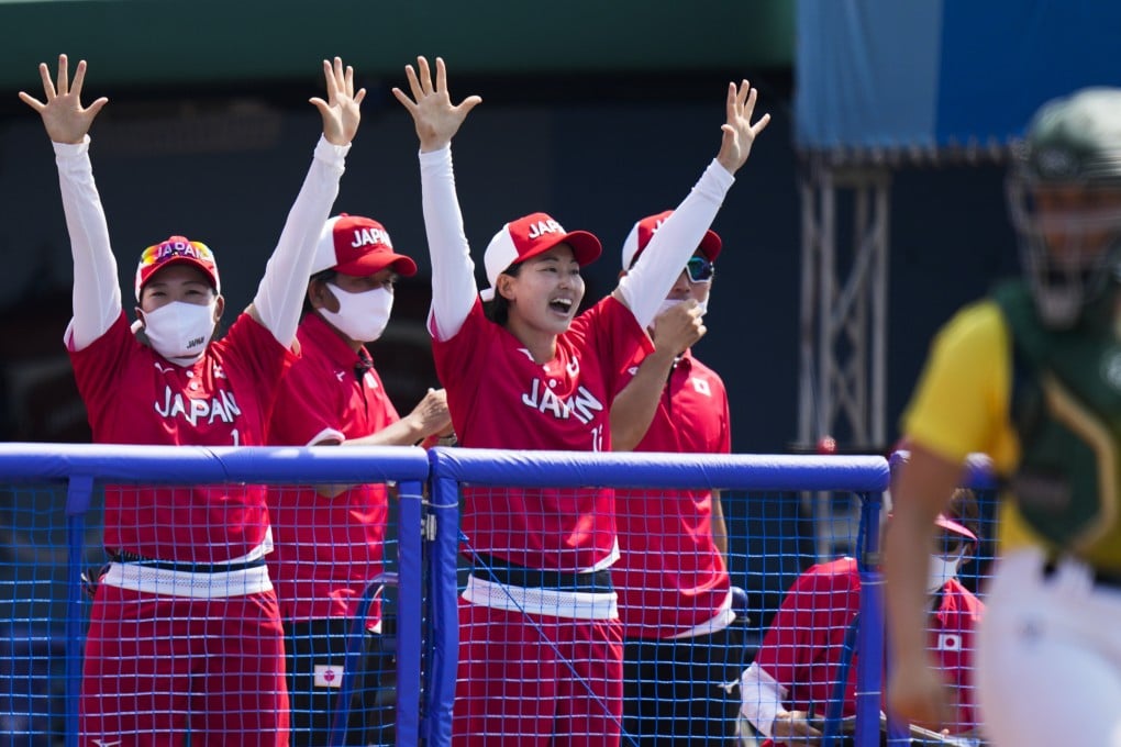 Japanese players celebrate a run scored by Minori Naito during the softball win over Australia, marking the unofficial start of the 2020 Tokyo Olympics. Photo: AP