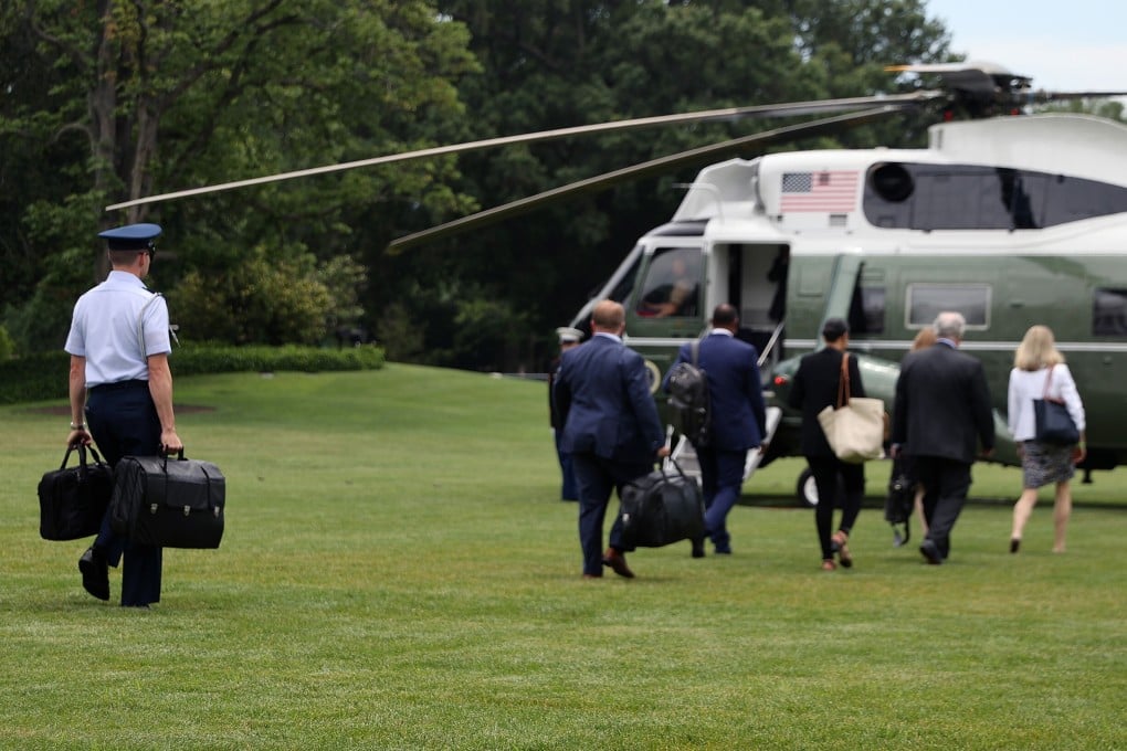 A military aide, left, carries the ‘nuclear football’ before boarding Marine One at the White House in Washington. Photo: TNS